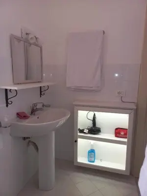 a bathroom with a sink and a mirror at Targa Moto Art in Palermo