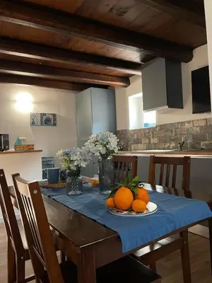 a dining room table with oranges and flowers on it at Casa di Reginaldo al Capo in Palermo