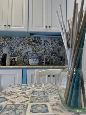 a kitchen with a table with a vase on it at Sea Diamond in Santa Flavia