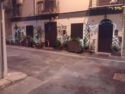 an empty street in front of a building at Casa Emilia in Palermo
