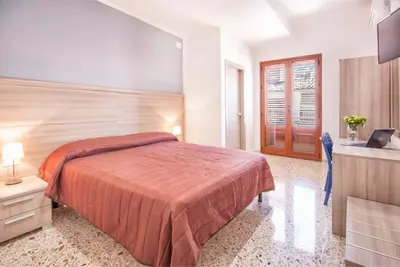 a hotel room with a bed and a television at B&B La Torre in Castellammare del Golfo