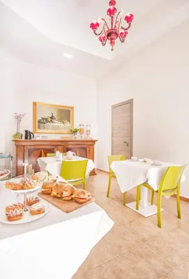 a dining room with a table with plates of food at B&B La Torre in Castellammare del Golfo