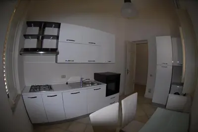 a kitchen with white cabinets and a stove at Villa 7 Palms Mondello Palermo Sicily in Palermo