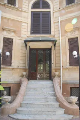 a building with a staircase leading to a door at Villa 7 Palms Mondello Palermo Sicily in Palermo