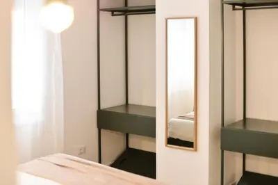 a bedroom with green shelves and a mirror at Residenza Ximenes Hub in Palermo