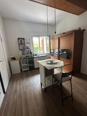a kitchen with a table and a dining room at Casa Vacanza Mondello nel Cuore in Mondello