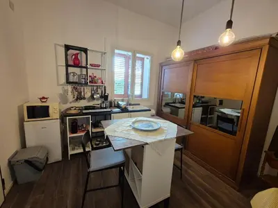 a kitchen with a table with a blue plate on it at Casa Vacanza Mondello nel Cuore in Mondello