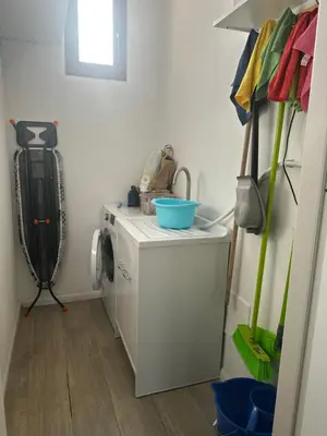 a laundry room with a washing machine and a washer at La Casetta di Gloria in Carini