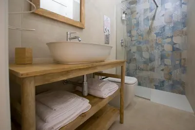a bathroom with a sink and a toilet at Massimo Rooms and suite in Palermo