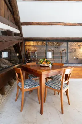 a wooden table with chairs and a bowl of fruit on it at Le Volte Del Basile - 4 camere private e terrazza in Palermo
