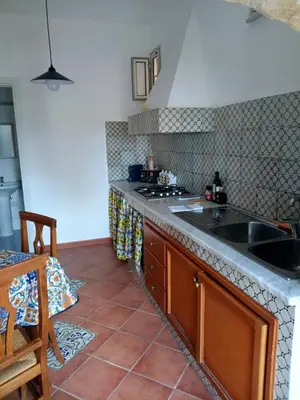 a kitchen with a sink and a counter top at Case Nereidi 1 in Porticello
