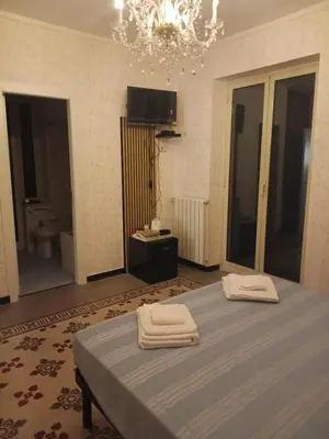 a bedroom with a bed with two towels on it at Case Nereidi 1 in Porticello