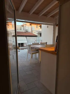 a kitchen with a table and a view of a patio at House sea view in Terrasini