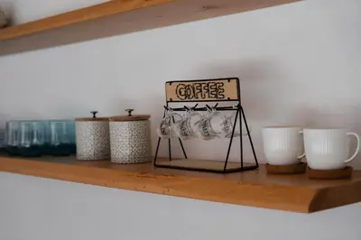 a shelf with cups and a sign on it at House sea view in Terrasini