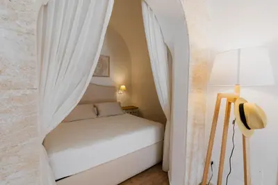 a small bedroom with a bed in an archway at House sea view in Terrasini