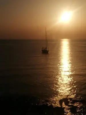a boat in the ocean at sunset at Case Nereidi 2 in Porticello