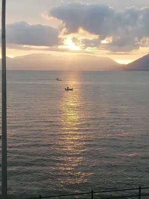 a group of boats in the water at sunset at Case Nereidi 2 in Porticello