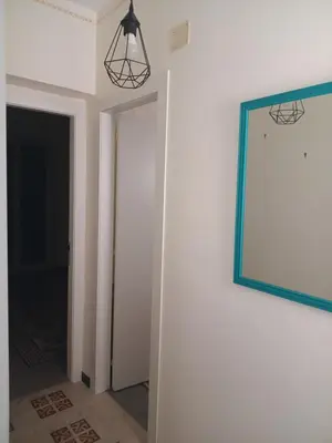 a mirror hanging on a wall next to a hallway at Case Nereidi 2 in Porticello