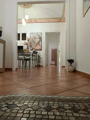 a living room with a table and a dining room at Mercury Apartment - 100 mq nel cuore di Palermo in Palermo