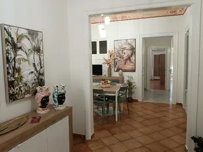 a living room with a table and a dining room at Mercury Apartment - 100 mq nel cuore di Palermo in Palermo