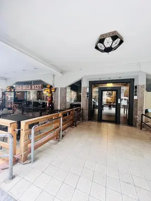 a lobby of a restaurant with a counter and benches at Michi House Appartamento in centro a Palermo in Palermo