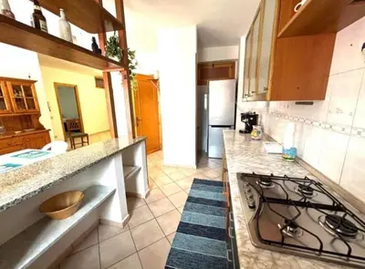 a kitchen with a stove and a counter top at Nelly's house in Terrasini