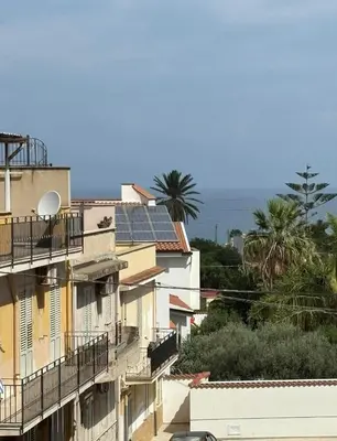 a group of buildings with solar panels on the roofs at Nelly's house in Terrasini