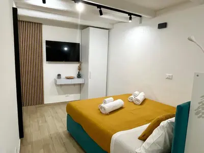 a bedroom with a bed with towels on it at La dolce casa in Palermo