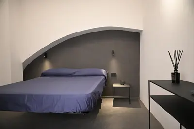 a bedroom with a bed with an arch above it at Suitt Drims 8 in Palermo