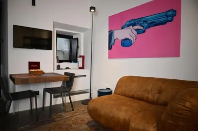 a living room with a couch and a gun on the wall at Suitt Drims 8 in Palermo