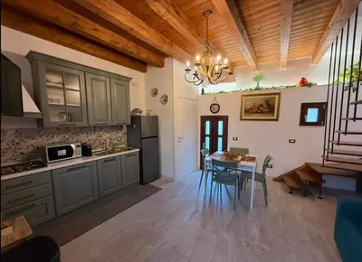 a kitchen with a table and a dining room at Cortile Cipriani in Palermo