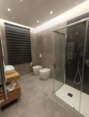 a bathroom with a shower and a toilet and a sink at Home Luxury Felice Marine in Palermo