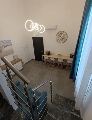 a room with a table and a bike hanging from a ceiling at Home Luxury Felice Marine in Palermo