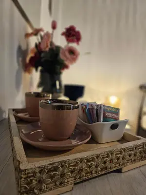 a table with three cups and plates on a wooden tray at Oasi Ballarak in Palermo