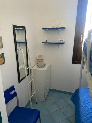 a room with a mirror and a dresser at San Vito Suite Apartament in San Vito lo Capo