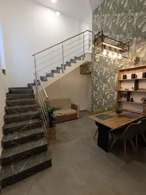 a staircase in a room with a table and a couch at Home Luxury Felice in Palermo