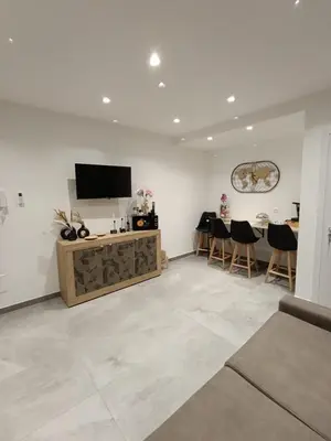 a living room with a television and a table and chairs at Home Luxury Felice in Palermo