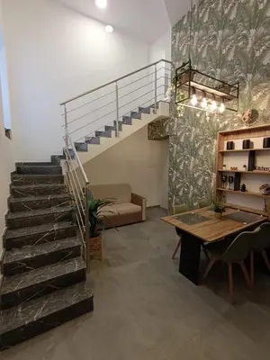 a staircase in a living room with a table at Home Luxury Felice in Palermo