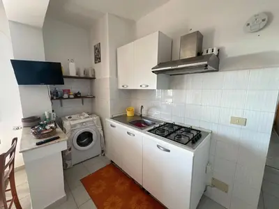 a kitchen with a stove and a washing machine at Villa Belvedere in Partinico