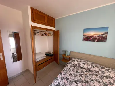 a bedroom with a bed and a small closet at Villa Belvedere in Partinico
