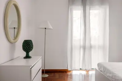 a bedroom with a bed and a mirror and a dresser at Cortile Benso Guest House in Palermo