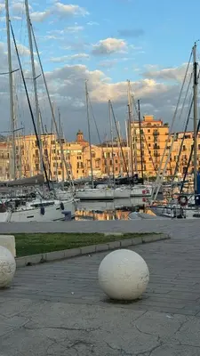 a group of boats parked in a marina with buildings at Cortile Benso Guest House in Palermo