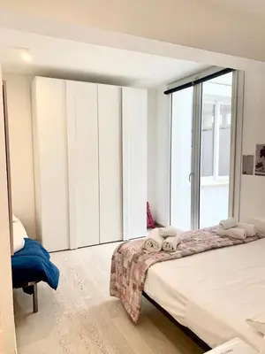 a bedroom with a bed and a large window at Casa Giulù in Palermo
