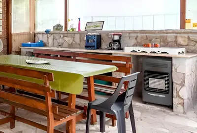 a kitchen with a table and chairs and an oven at Casa Giulù in Palermo