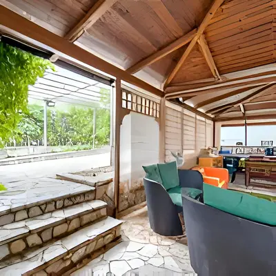 an outdoor living room with chairs and a table at Casa Giulù in Palermo