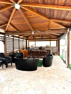 a pavilion with chairs and tables and a wooden ceiling at Casa Giulù in Palermo