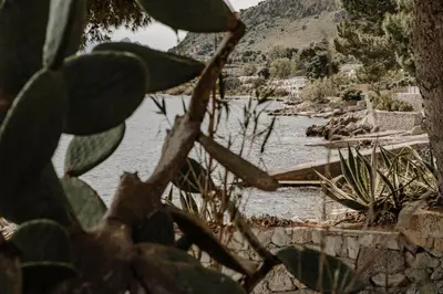 a view of a river from behind a plant at La Perla d'Argento in Santa Flavia
