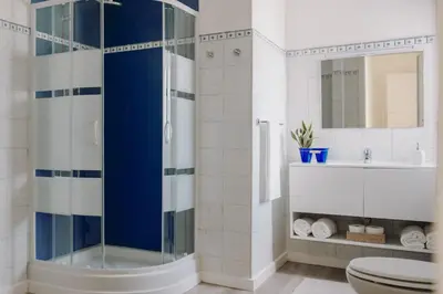 a bathroom with a shower and a toilet and a sink at La Perla d'Argento in Santa Flavia