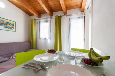 a dining room table with bananas and plates on it at Casa Vacanze del Golfo in Castellammare del Golfo