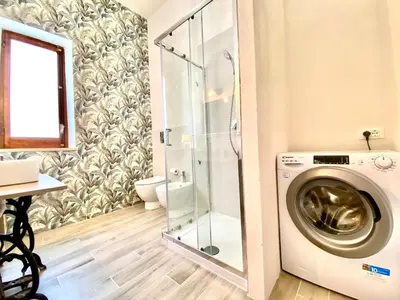 a bathroom with a washing machine and a shower at Riva Marina, sulla spiaggia in Alcamo
